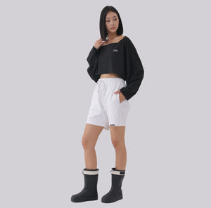 White London Clothing black oversized cropped sweatshirt with square neckline and white logo detail, paired with white shorts.