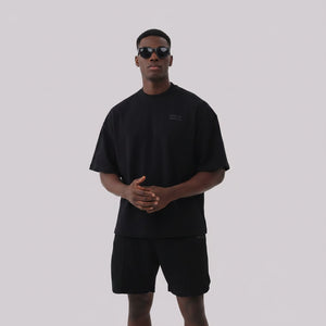 White London Clothing black oversized textured shorts made from heavyweight cotton jersey with an elasticated waistband and subtle logo detail.
