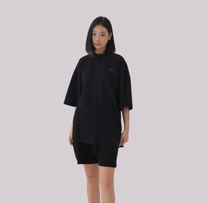 White London Clothing black oversized textured jersey shorts with elasticated waistband and subtle logo detail.