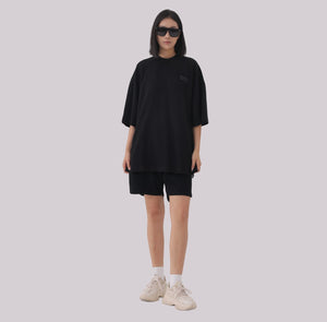 White London Clothing black oversized textured shorts made from heavy weight cotton jersey with an elasticated waistband and subtle logo accent.
