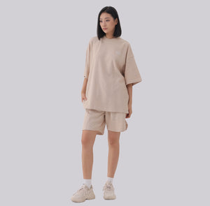 White London Clothing beige oversized textured shorts made from heavy weight cotton jersey with an elasticated waistband and subtle logo accent.