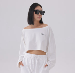 White London Clothing white oversized fit long sleeve cropped sweatshirt with black logo detail on chest.