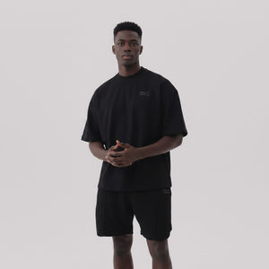 White London Clothing black oversized textured shorts made from heavyweight cotton jersey with an elasticated waistband and subtle logo detail.