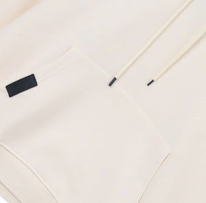 White London Clothing cream beige 100% cotton hoodie with drawstring and embossed logo tag on pocket.