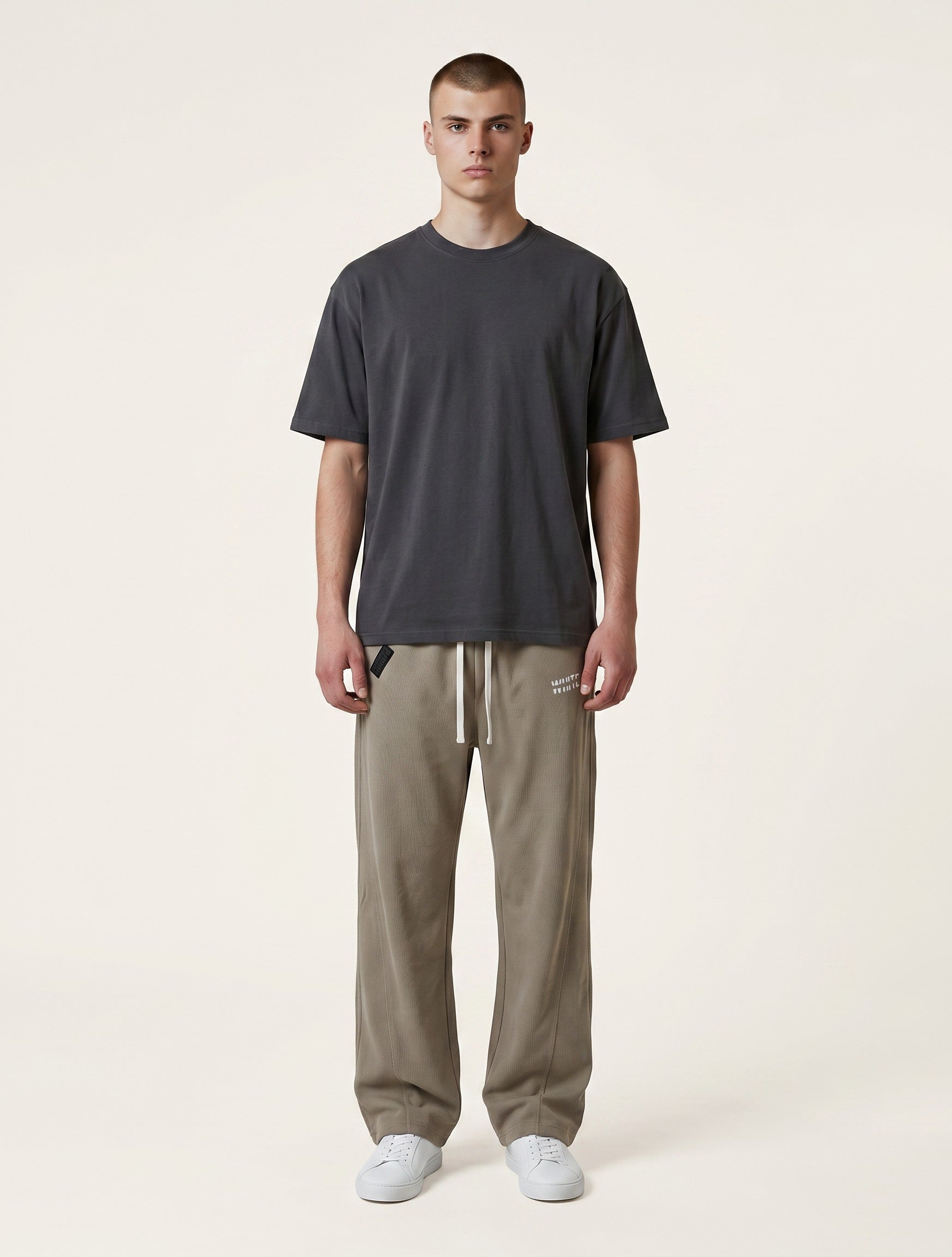 White London Clothing beige corduroy relaxed fit trousers with drawstring waist and embroidered logo.