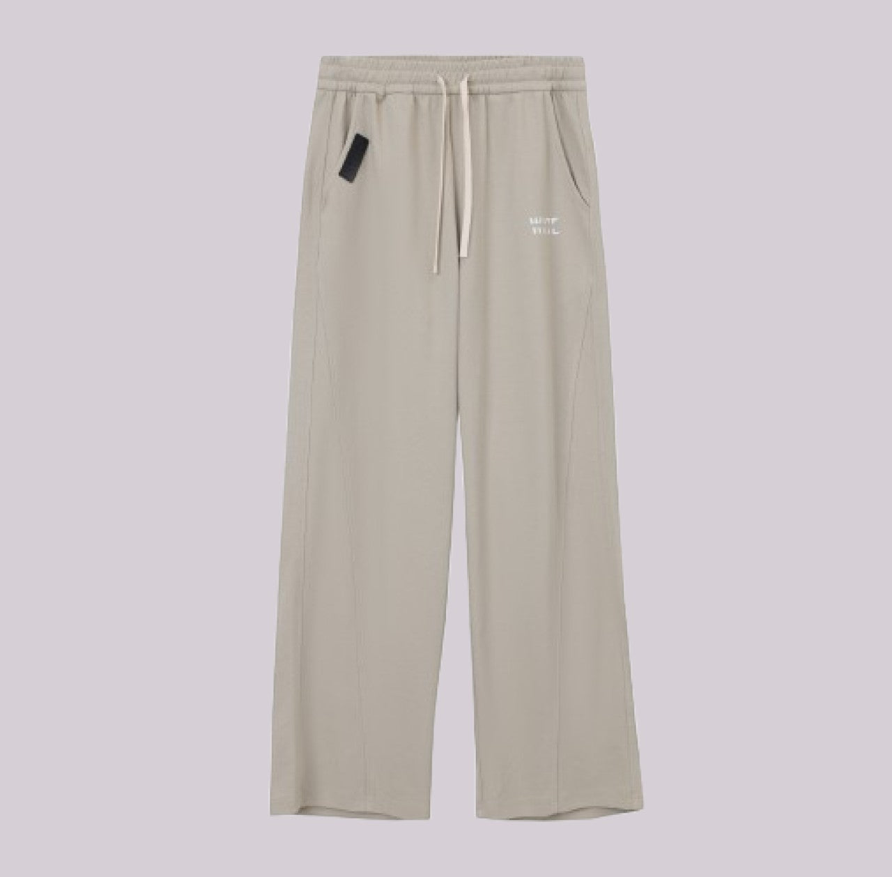 White London Clothing beige relaxed fit trousers with drawstring waist and subtle logo detail.