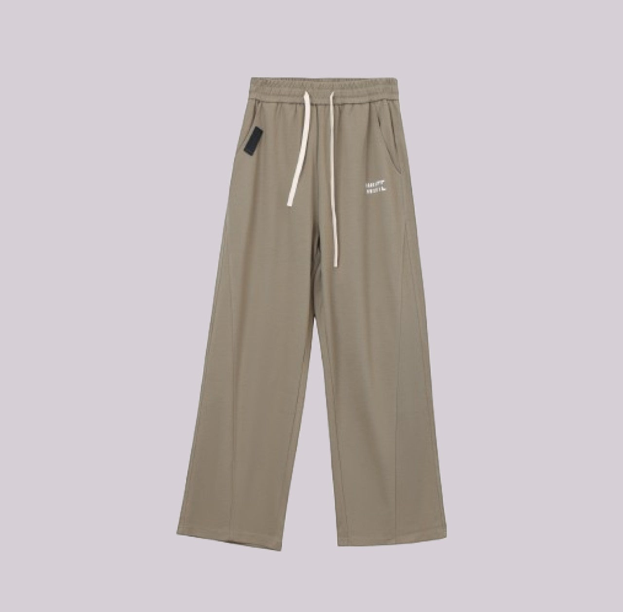 White London Clothing beige relaxed fit trousers with drawstring and subtle logo detail.