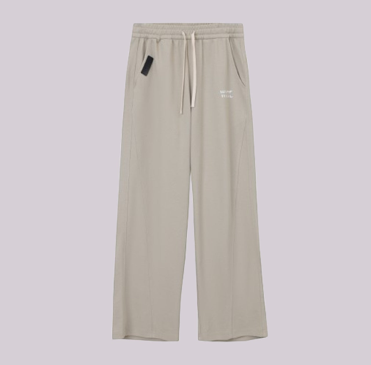 White London Clothing beige relaxed fit trousers with drawstring waist and subtle logo detail.