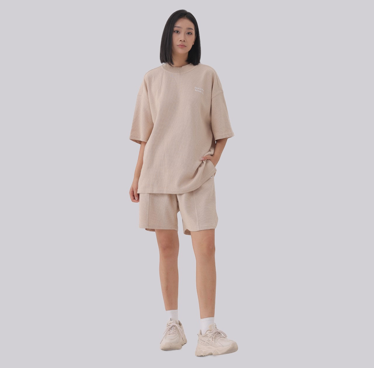 White London Clothing beige oversized textured shorts made from heavy weight cotton jersey with an elasticated waistband and subtle logo accent.