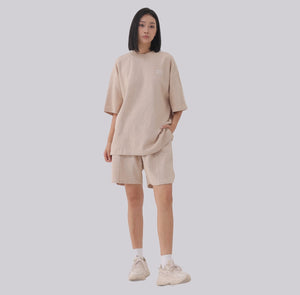 White London Clothing beige oversized textured shorts made from heavy weight cotton jersey with an elasticated waistband and subtle logo accent.