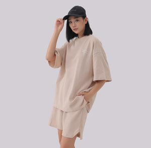 White London Clothing beige oversized textured shorts made from heavy weight cotton jersey with an elasticated waistband and side pockets.