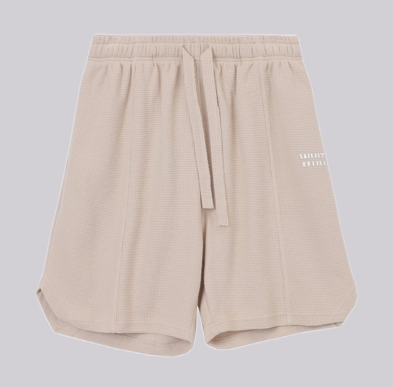 White London Clothing beige oversized textured waffle knit cotton shorts with drawstring waist and logo accent.