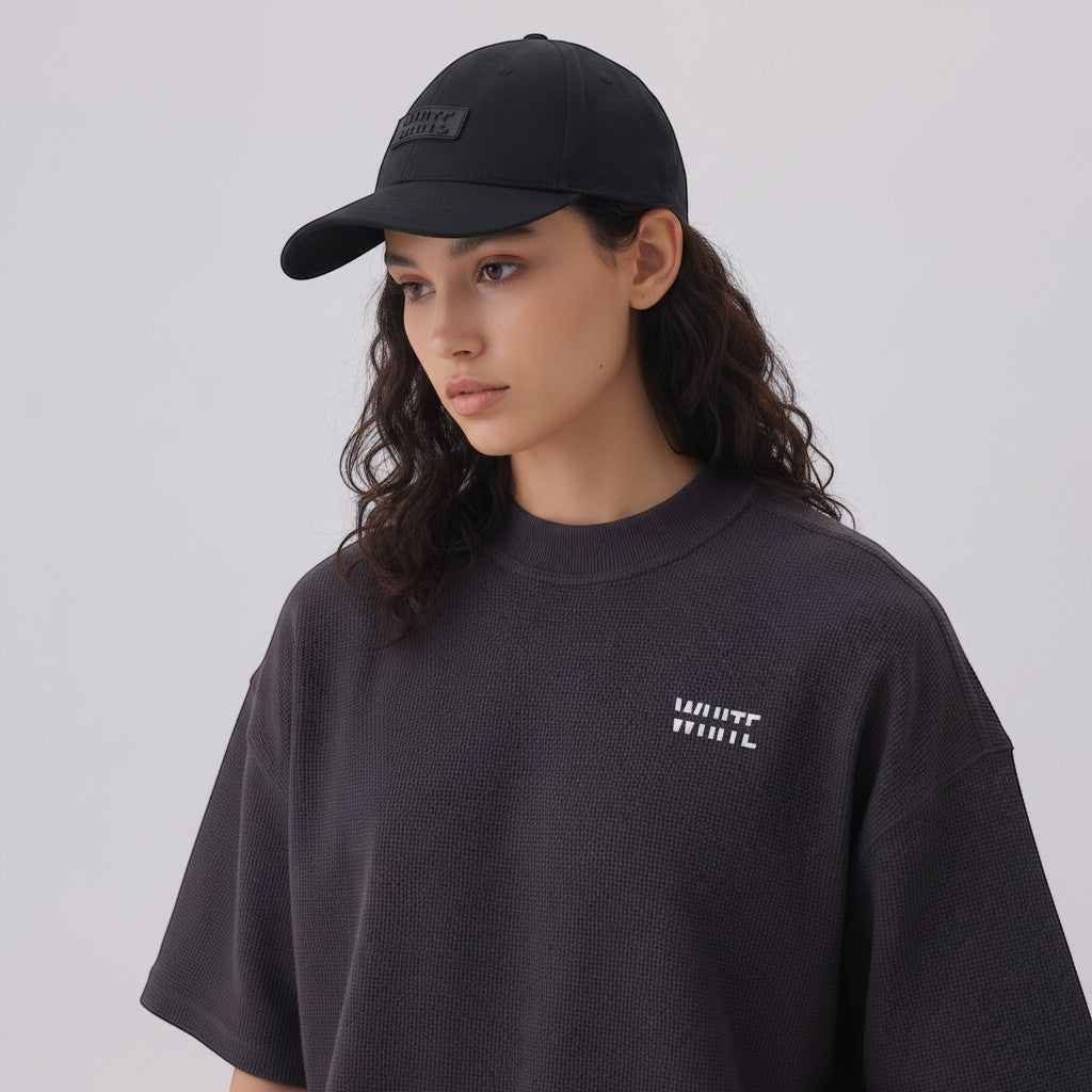 White London Clothing black cotton twill baseball cap with tonal embroidered patch and pre-curved brim.