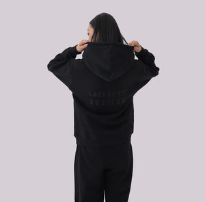 White London Clothing black 100% cotton hoodie with large logo print on back and small logo on chest. Model wearing size M.