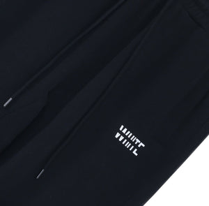 White London Clothing black cotton jersey joggers with white logo print on left thigh and drawstring waist.