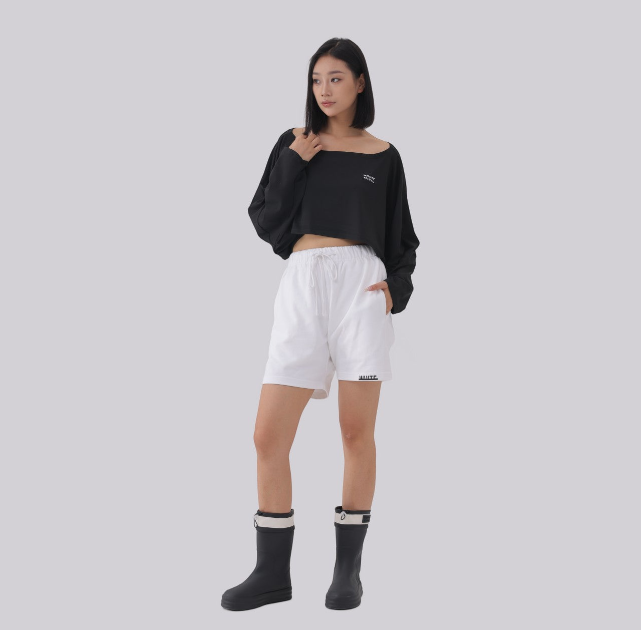 White London Clothing black oversized cropped sweatshirt with wide neckline, paired with white drawstring shorts with logo detail.