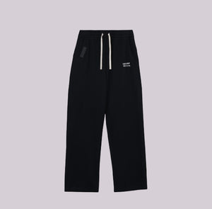 White London Clothing black relaxed fit trousers with drawstring waist and subtle logo detail.