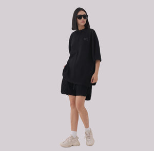 White London Clothing black oversized textured shorts made from heavy weight jersey cotton with an elasticated waistband and subtle logo accent.