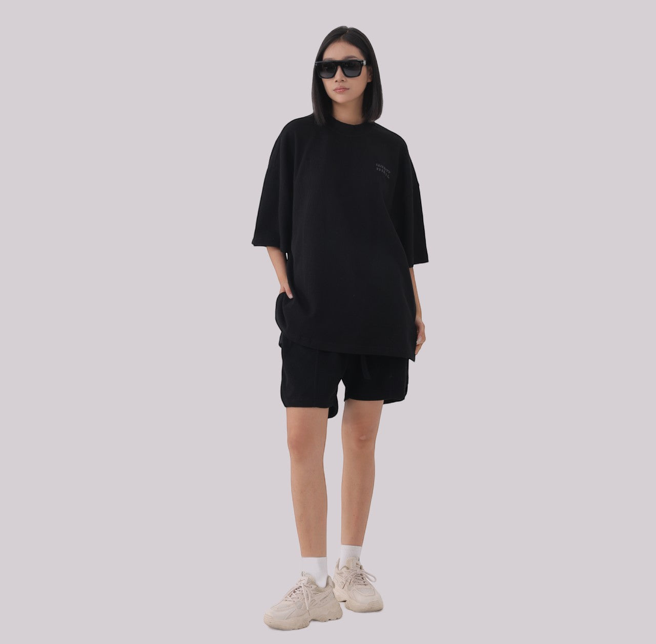 White London Clothing black oversized textured shorts made from heavy weight jersey cotton with an elasticated waistband and side pockets.