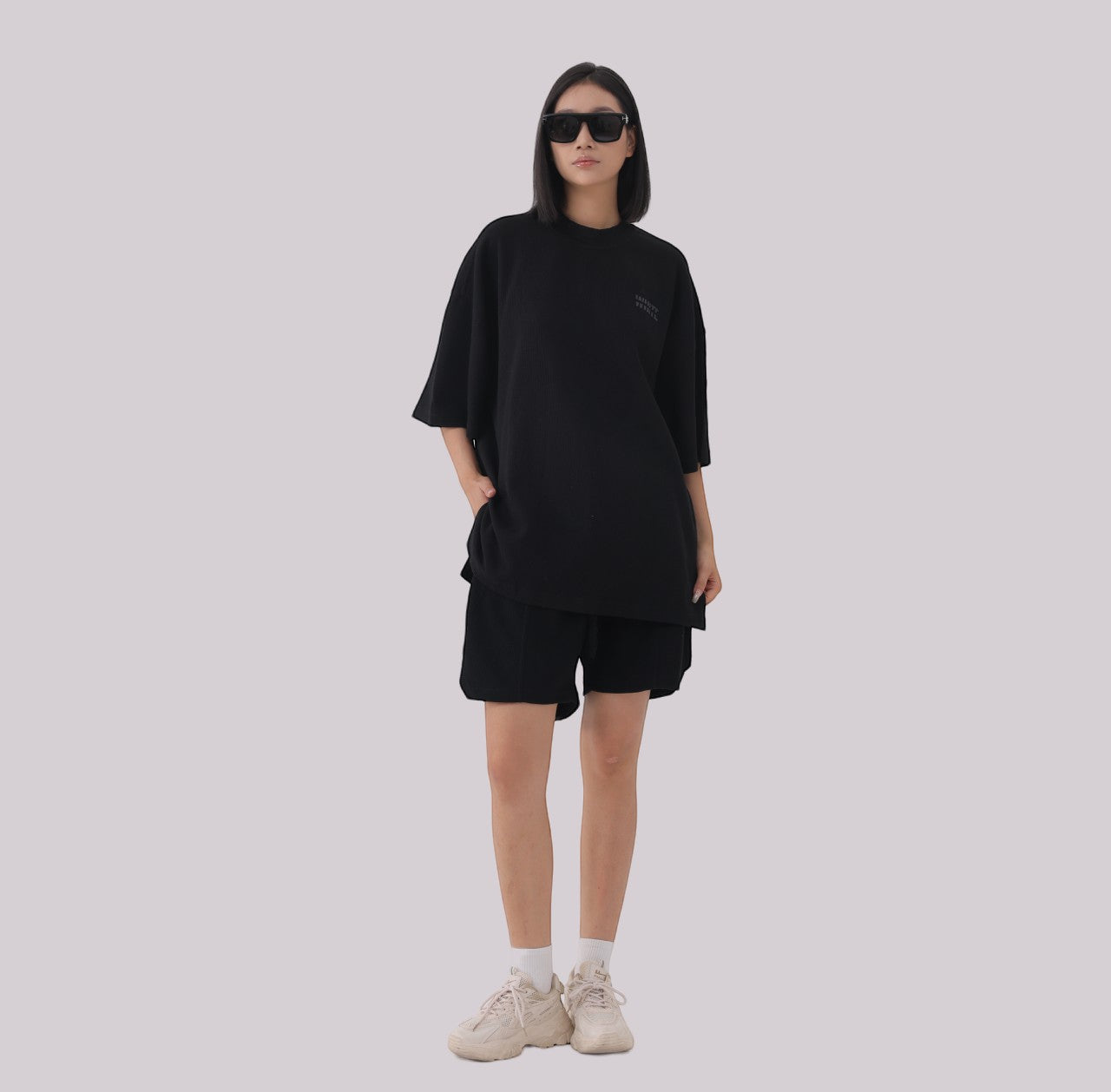 White London Clothing black oversized textured shorts made from heavy weight jersey cotton with an elasticated waistband and subtle logo accent.
