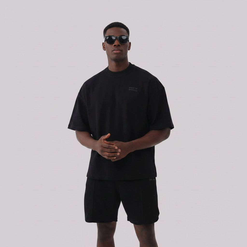 White London Clothing black oversized textured shorts made from heavyweight cotton jersey with an elasticated waistband and subtle logo detail.