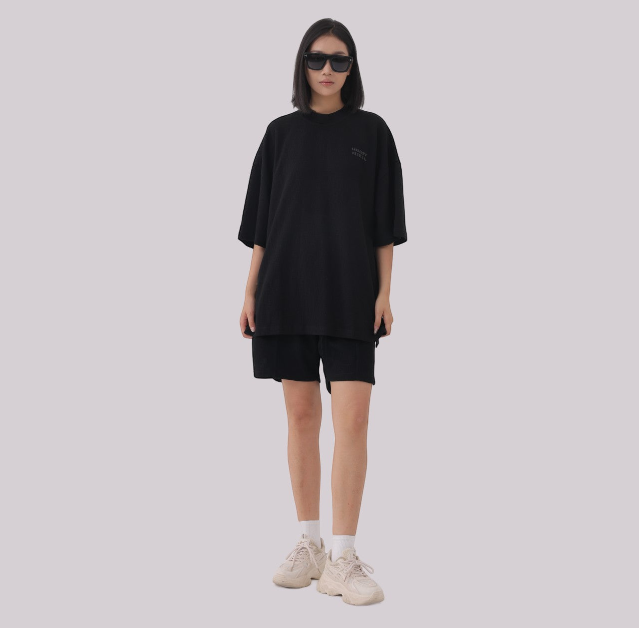 White London Clothing black oversized textured shorts made from heavy weight cotton jersey with an elasticated waistband and subtle logo accent.