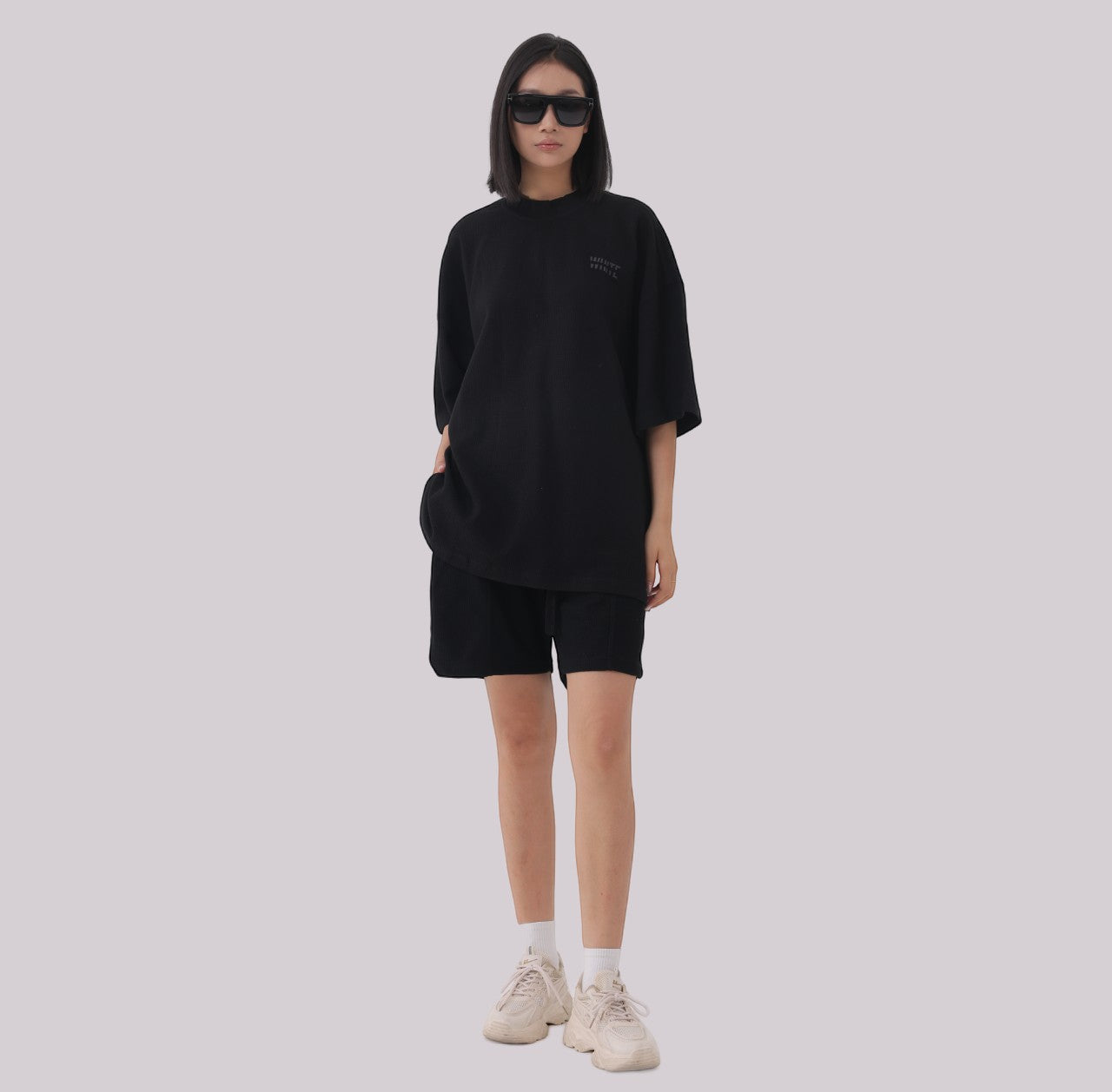 White London Clothing black oversized textured shorts made from heavy weight jersey cotton with an elasticated waistband and subtle logo accent.