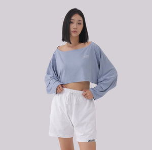 White London Clothing light blue oversized fit long sleeve cropped sweatshirt with white logo detail on chest.