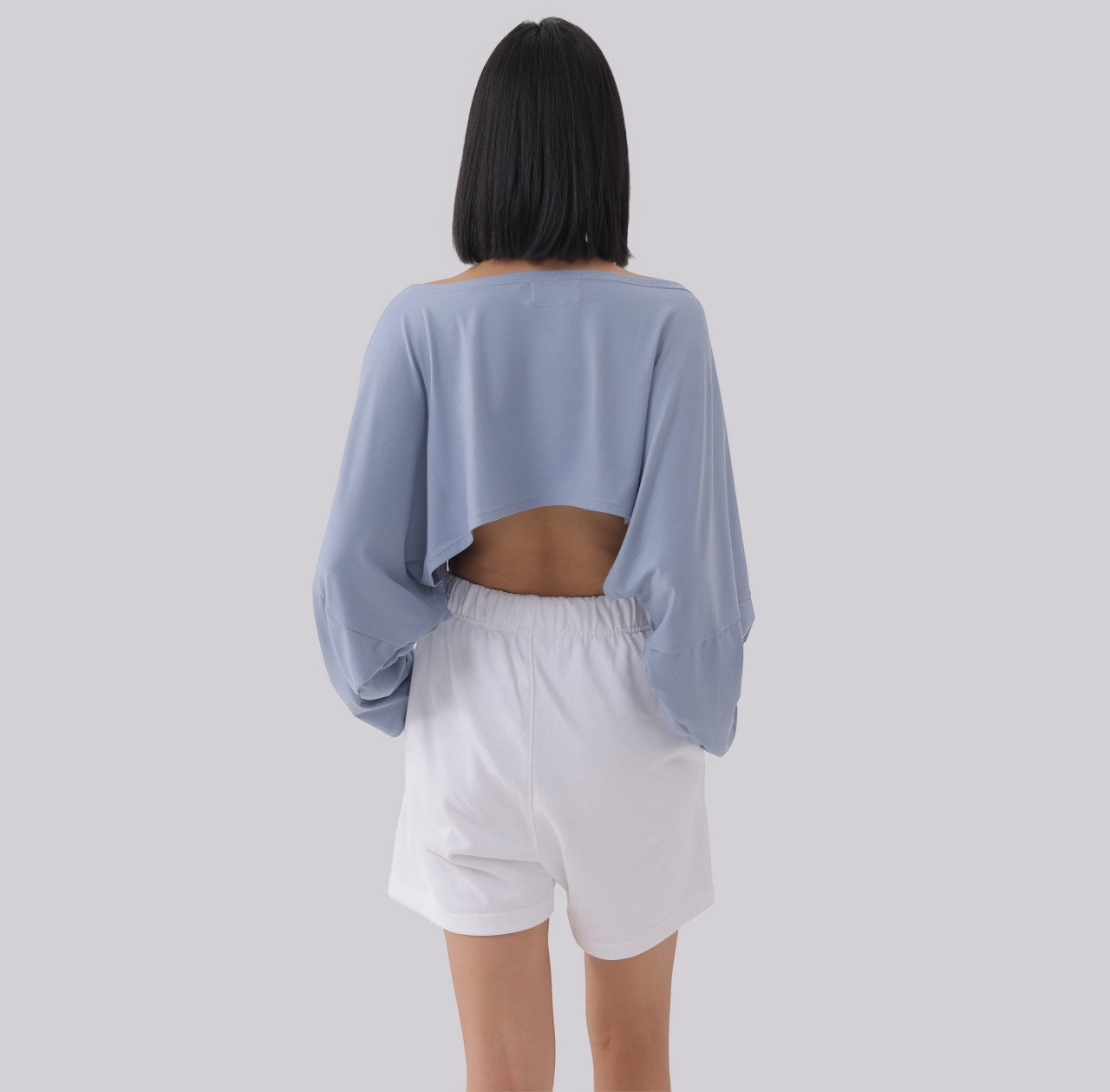 White London Clothing light blue oversized fit long sleeve cropped sweatshirt with open back detail.