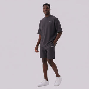 White London Clothing charcoal grey oversized textured shorts with elasticated waistband and logo accent on left leg.