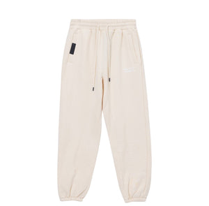 White London Clothing cream cotton jersey joggers with signature silhouette, cropped length, and white logo on left thigh.