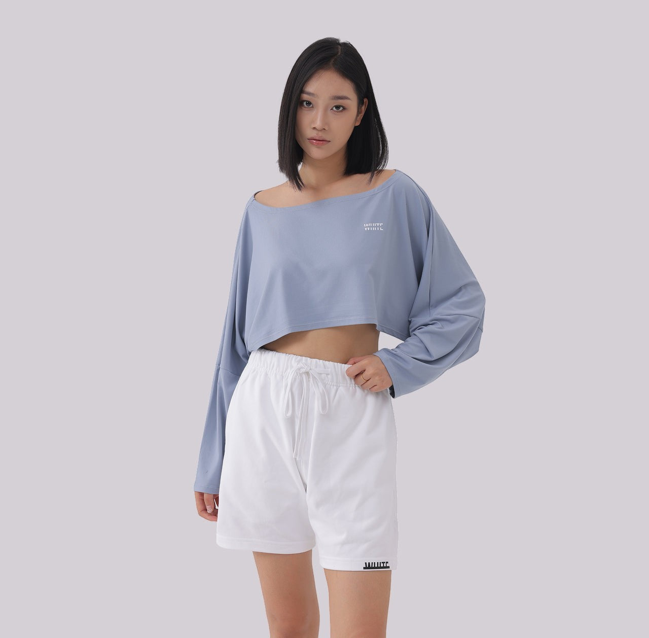 White London Clothing dusty blue oversized fit long sleeve cropped sweatshirt with white logo detail on chest.
