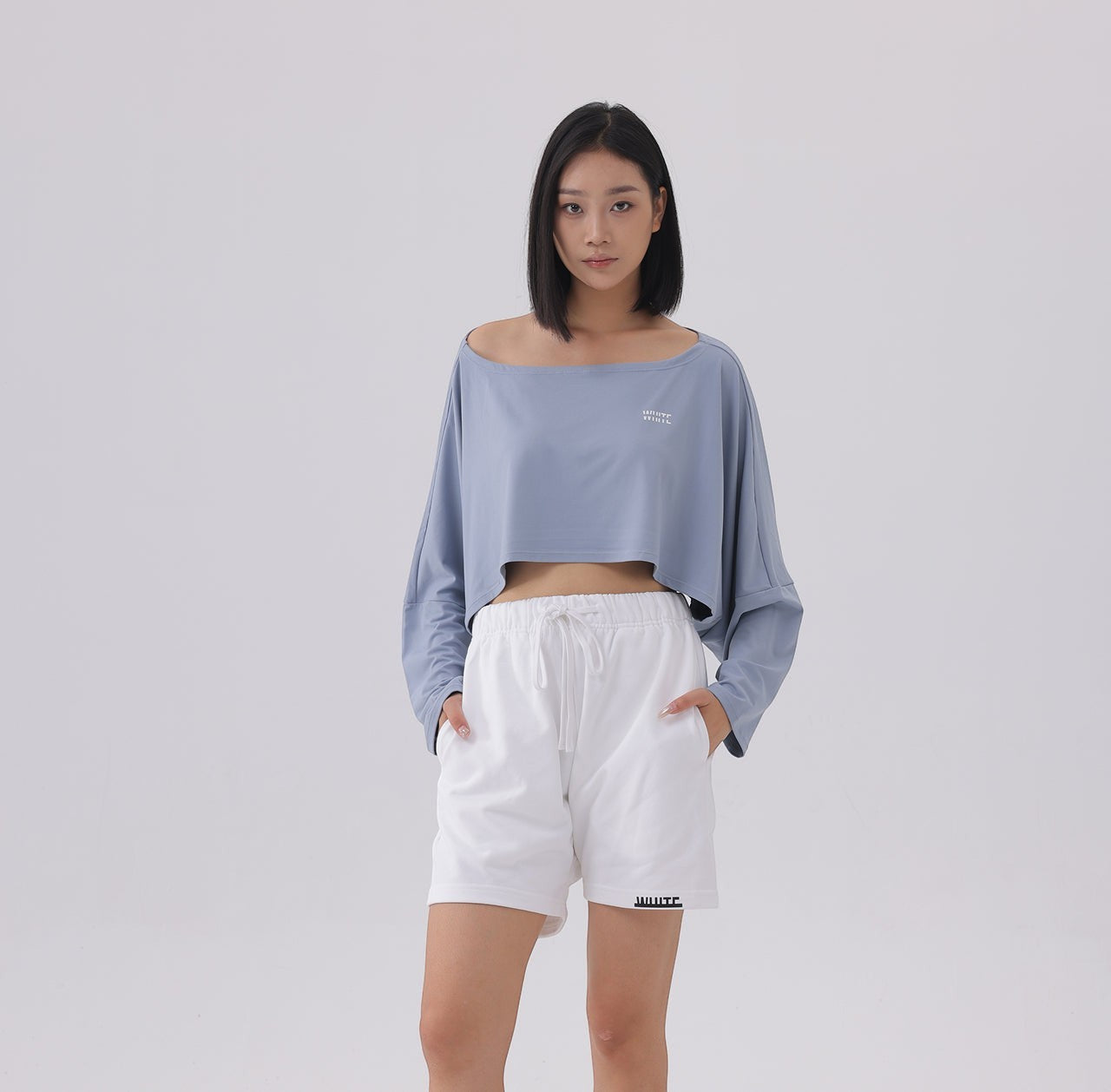 White London Clothing dusty blue oversized fit long sleeve cropped sweatshirt with white logo detail.