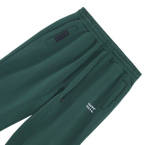 White London Clothing dark green cotton jersey joggers with cropped length, drawstring waist, and white logo detail on left thigh.