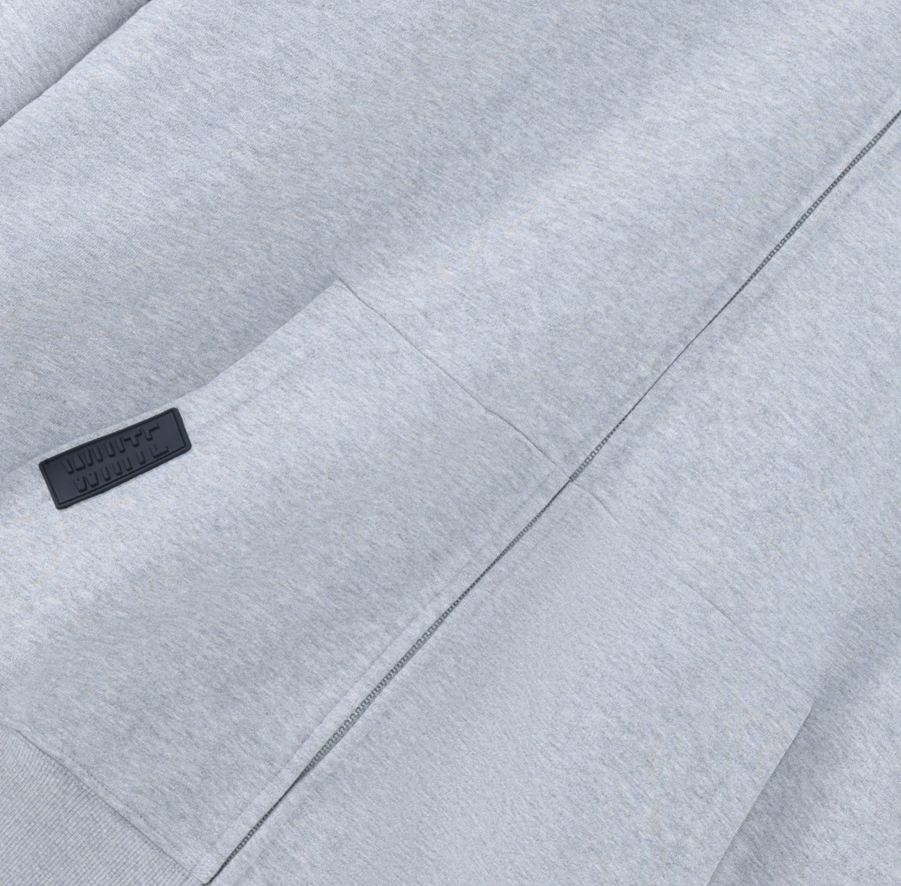 White London Clothing grey jersey zip-up hoodie with dropped shoulders and a black logo patch on the chest.