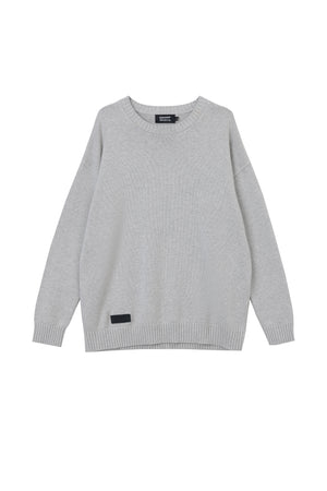 White London Clothing light grey oversized merino wool blend sweater with textured boucle yarn and embossed logo tag.