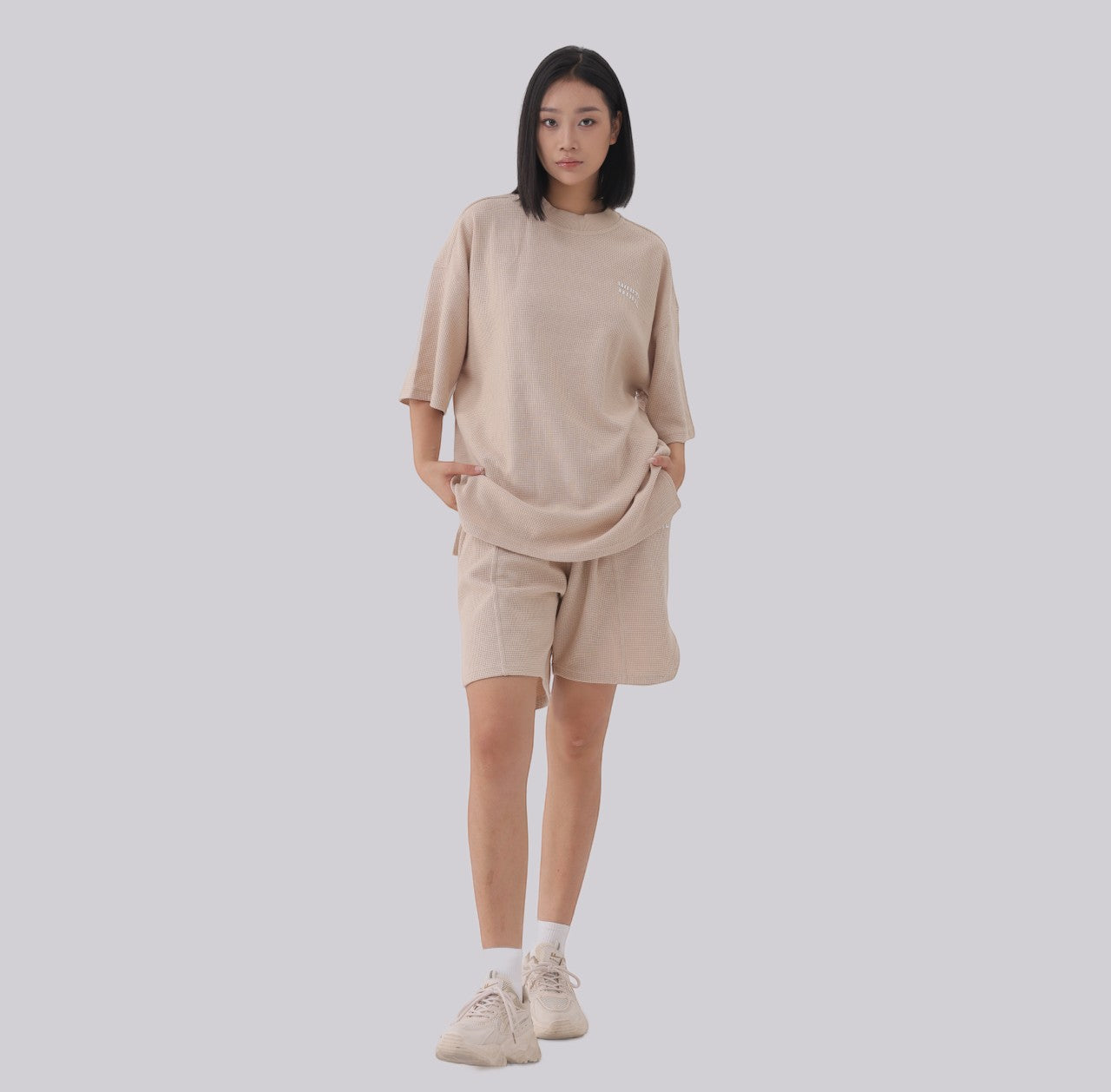 White London Clothing beige oversized textured shorts made from heavy weight cotton jersey with an elasticated waistband and side pockets.