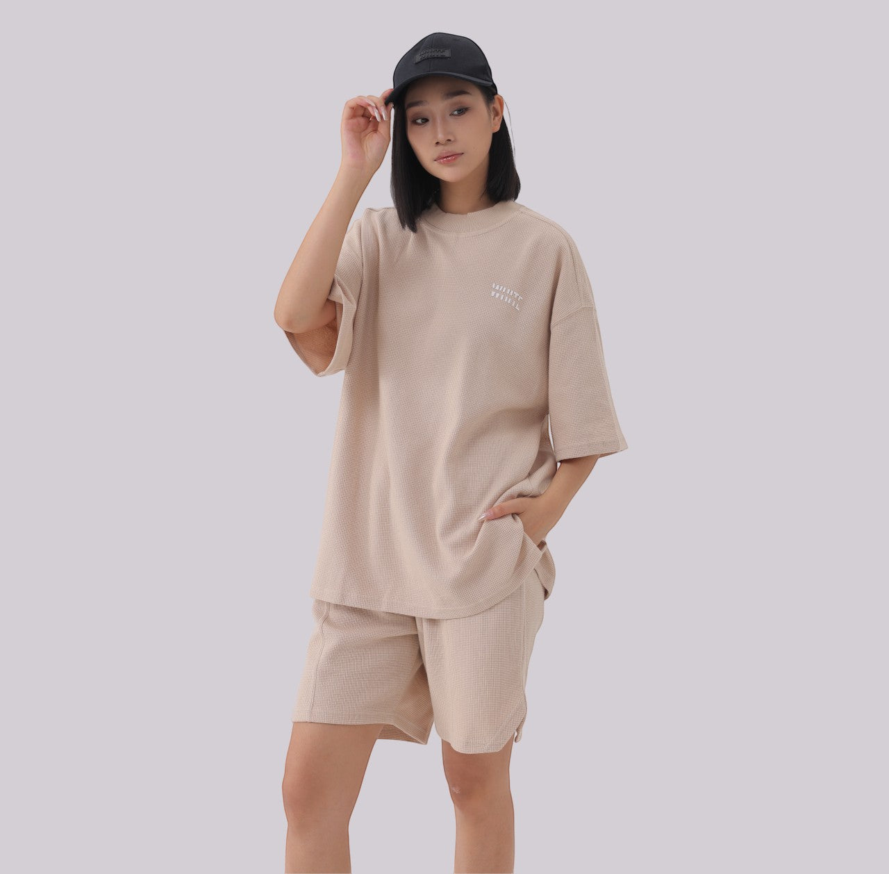 White London Clothing beige oversized textured shorts made from heavy weight cotton jersey with an elasticated waistband and side pockets.