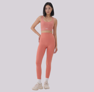 White London Clothing coral pink sculpt sports bra with spaghetti straps and removable padding.