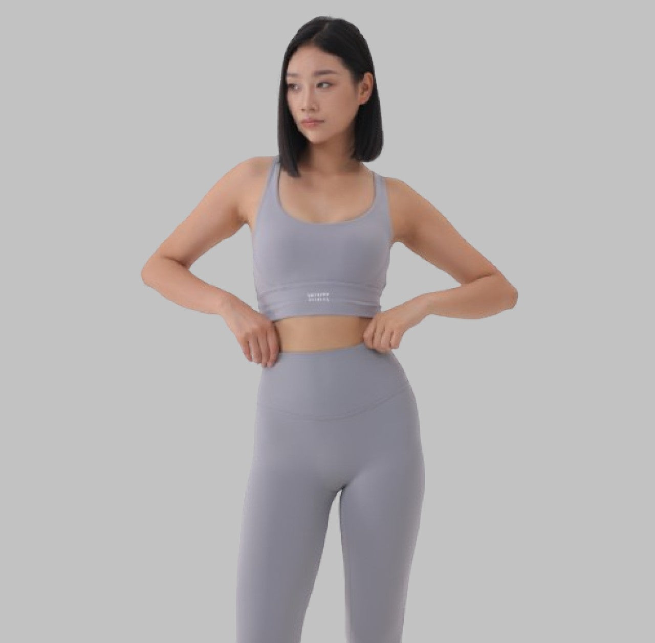 White London Clothing light grey sculpt sports bra with spaghetti straps and removable padding. Moisture-wicking fabric.