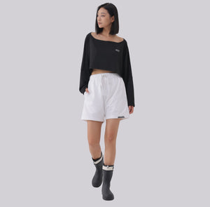 White London Clothing white cotton jersey cropped sweatshirt with long sleeves and a boat neck, paired with white drawstring shorts.