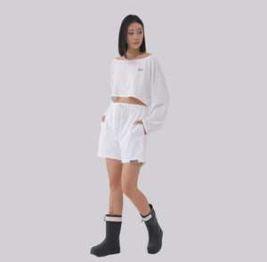 White London Clothing white oversized fit long-sleeved cropped sweatshirt with a boat neck and black logo detail.