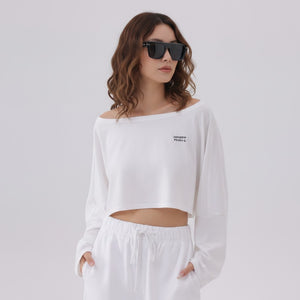 White London Clothing white oversized fit long-sleeved cropped sweatshirt with logo detail on chest.