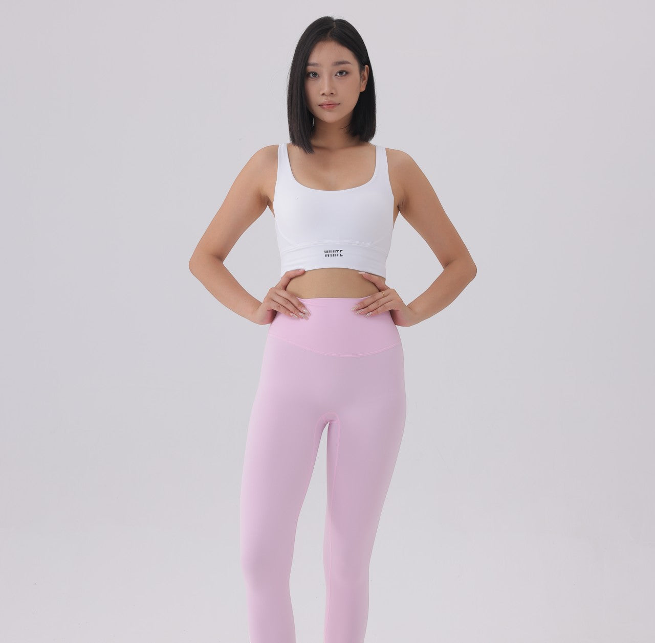 White London Clothing women's white sculpt sports bra with spaghetti straps and removable padding, paired with pink leggings.