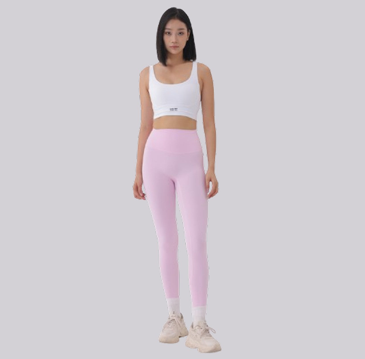 White London Clothing women's white sculpt sports bra with spaghetti straps and light pink leggings. Moisture-wicking fabric.