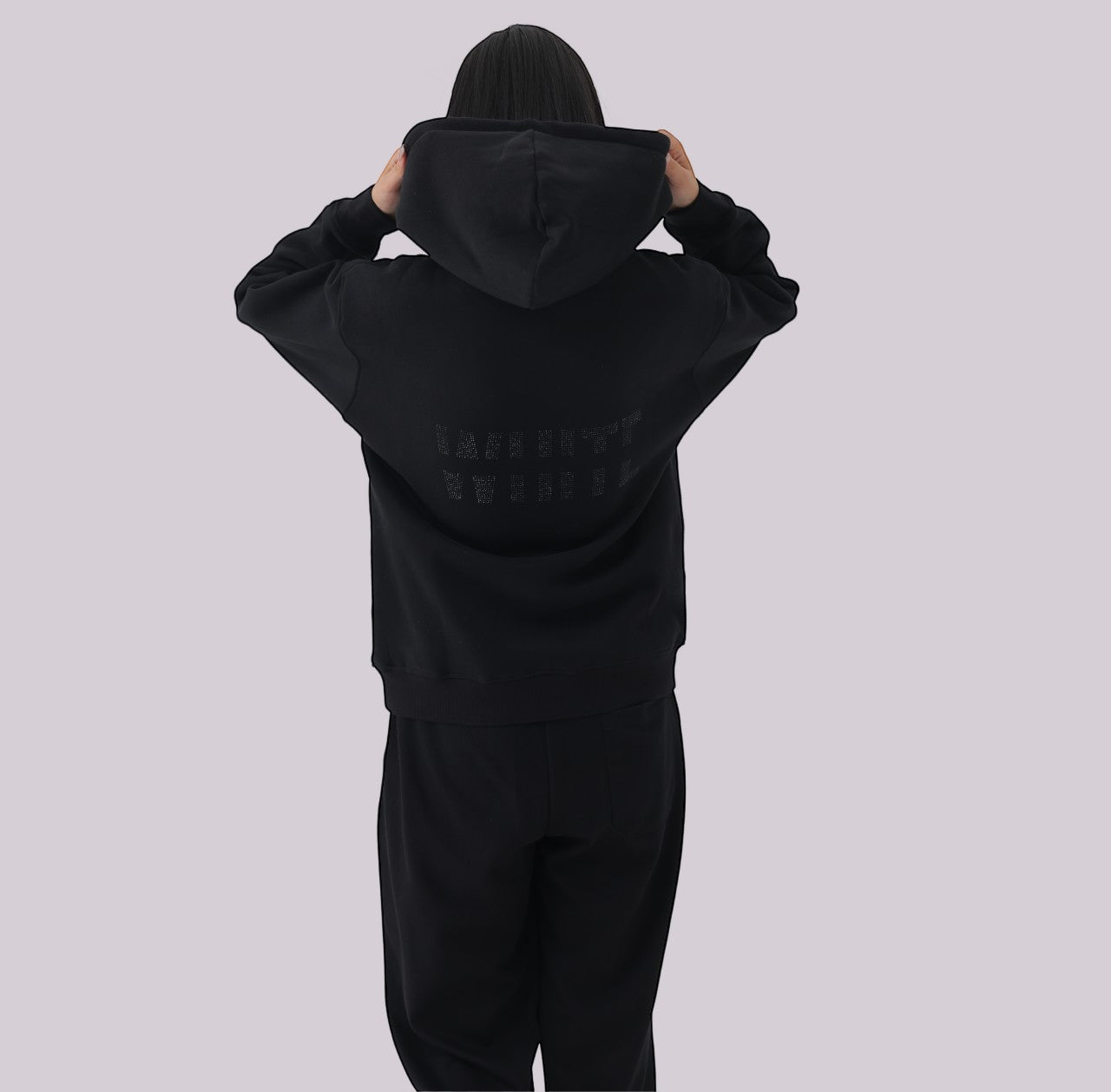 White London Clothing black 100% cotton hoodie with a double-lined hood and printed logo on the back. Model is wearing a size medium.