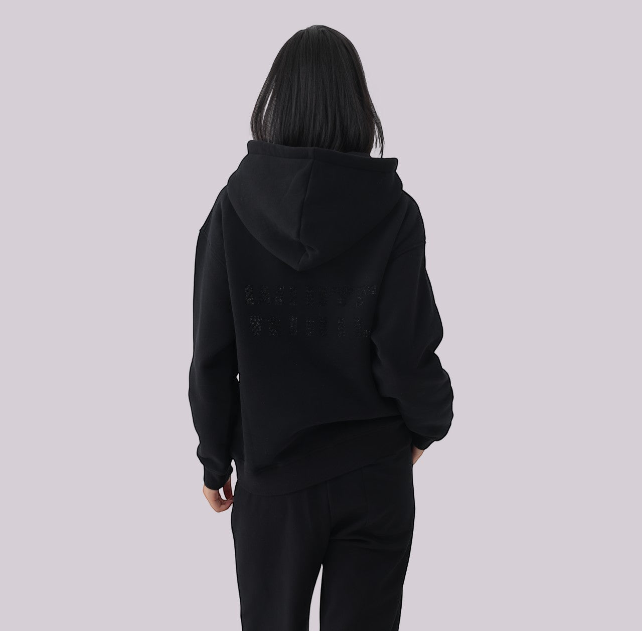 White London Clothing black 100% cotton hoodie with large logo print on back and embossed logo tag on pocket. Model wearing medium.