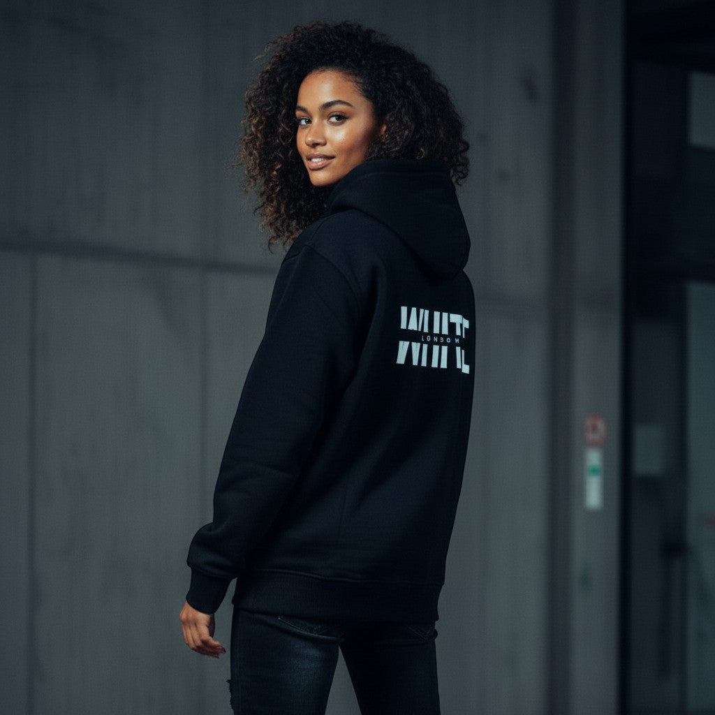White London Clothing black 100% cotton hoodie with large white logo print on back and small logo on chest. Model wears size M.