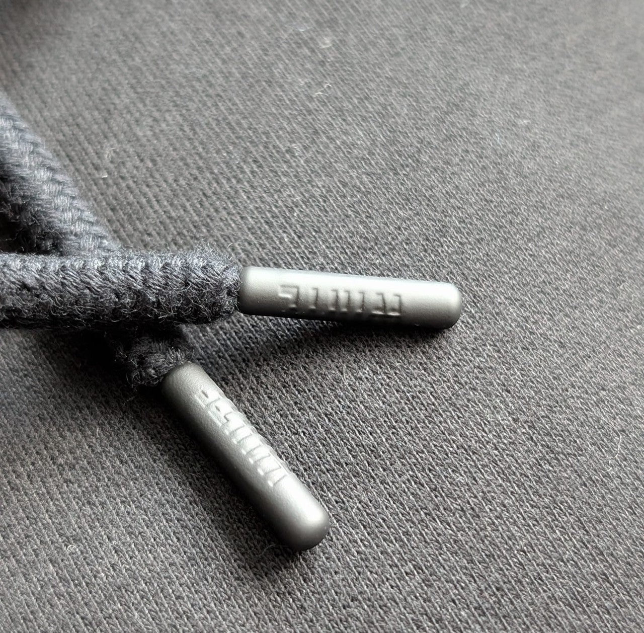 White London Clothing charcoal grey 100% cotton hoodie drawstring aglets with embossed logo detail.