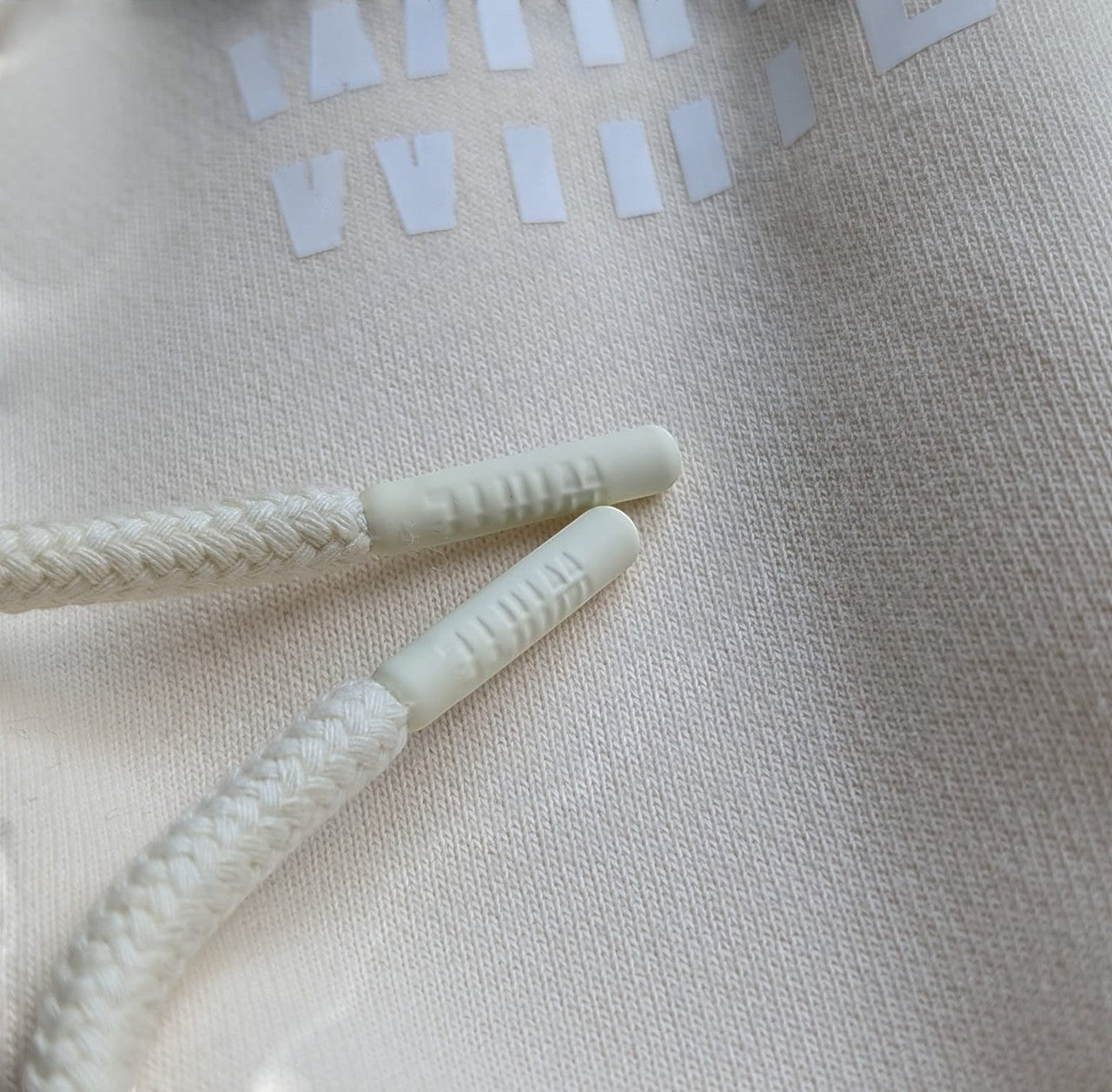 White London Clothing cream 100% cotton hoodie with drawstring details and embossed logo on pocket.